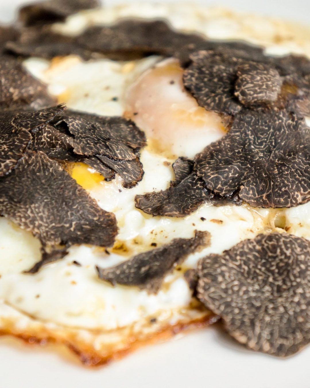 Fried eggs with truffle chips closeup